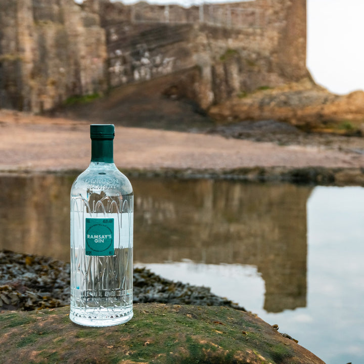 Bottle of Gordon Ramsay Gin on the coast at St Andrews