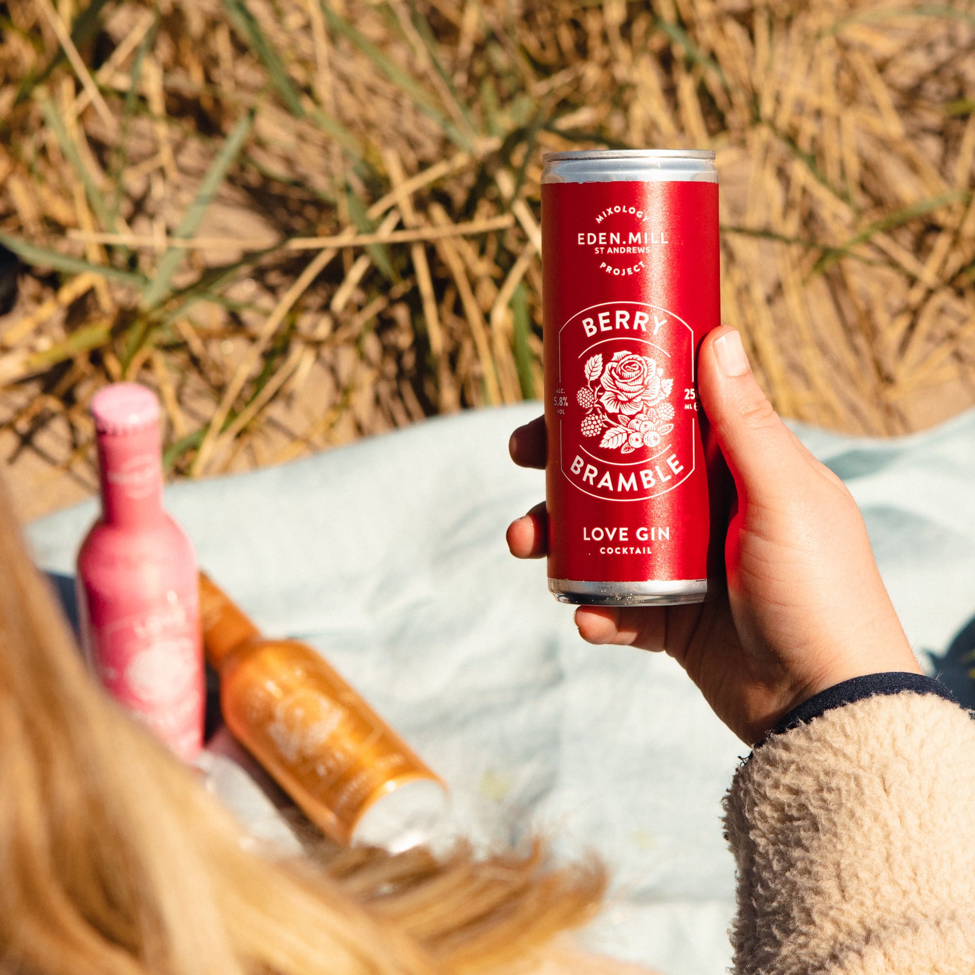 hand holding a can of berry bramble canned cocktail