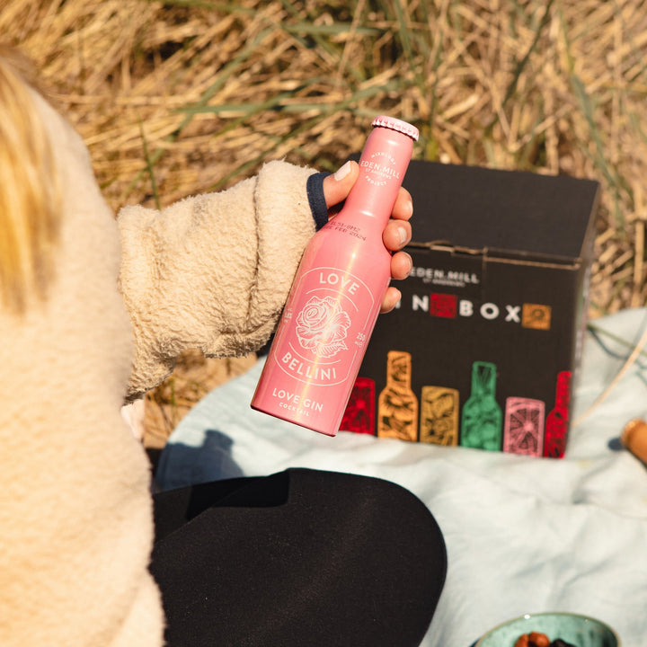 Girl holding an bottle of Love Bellini Cocktail