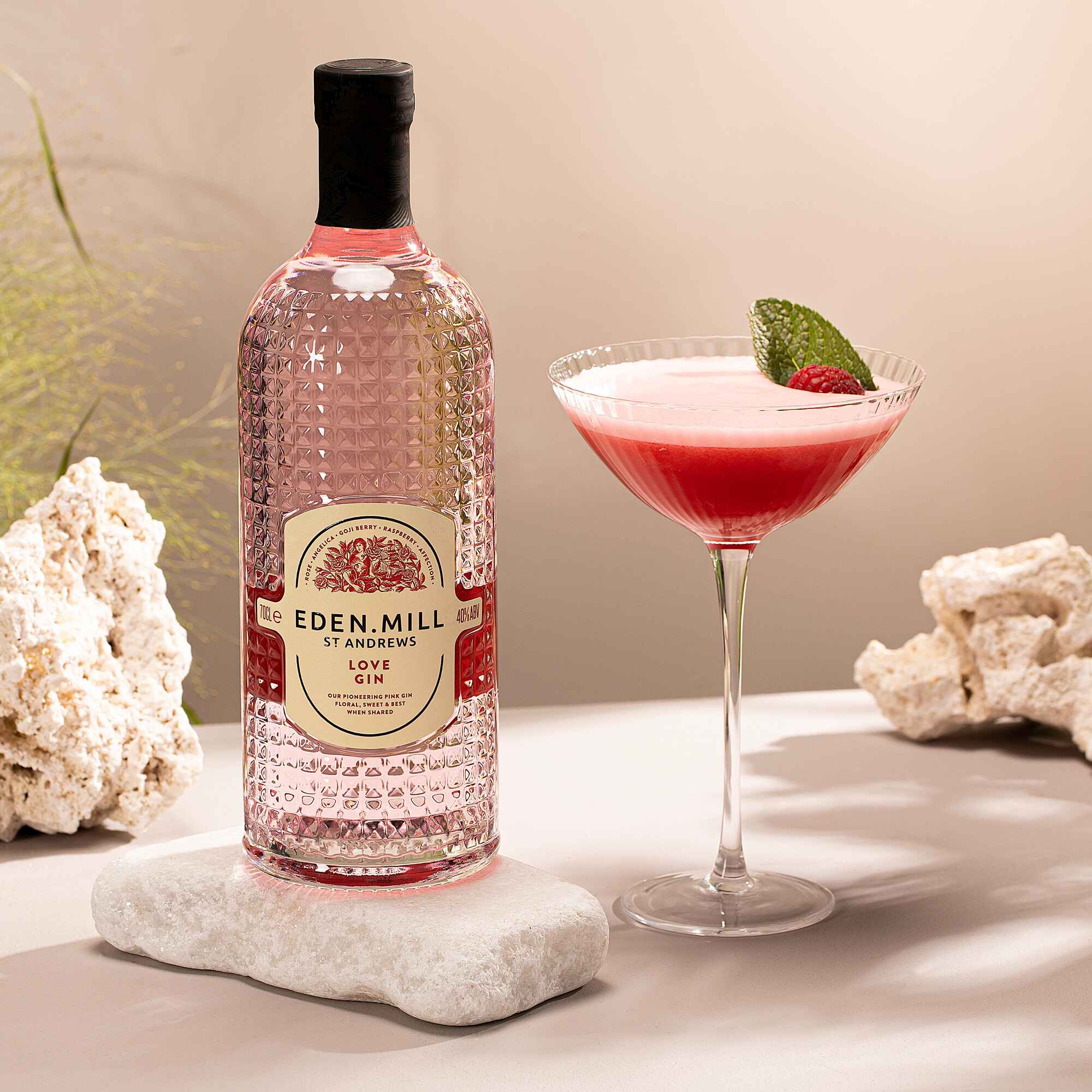 Bottle of Love Gin with Coupe Glass filled with red cocktail