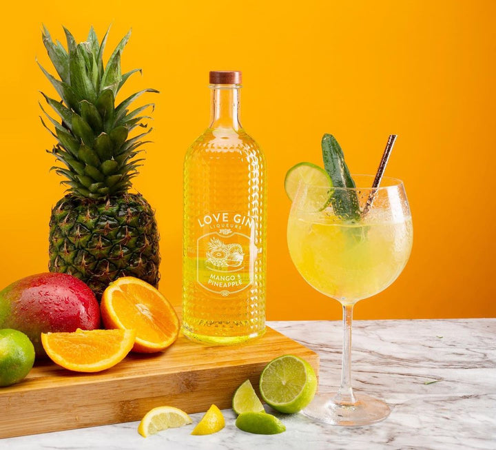 Mango and Pineapple Gin Liqueur Bottle with strainer and gin goblet with cocktail